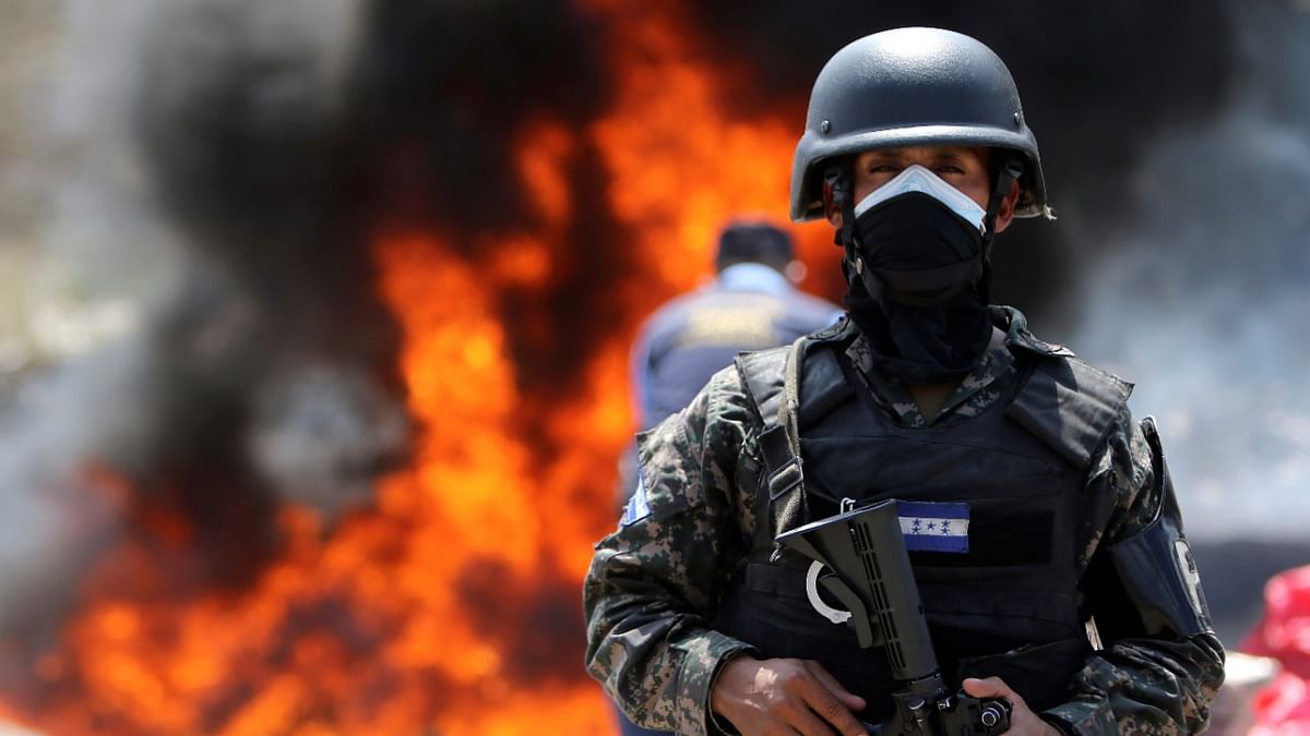 A military police officer keeps watch during the incineration of packages of cocaine, seized during different police operations, in Tegucigalpa, Honduras. Credit: Reuters Photo