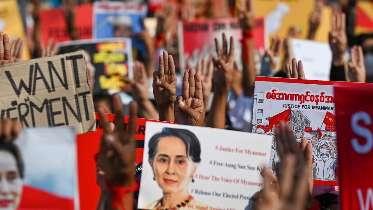 Protesters hold up the three finger salute with signs calling for the release of detained Myanmar civilian leader Aung San Suu Kyi during a demonstration against the military coup in Yangon. Credit: AFP Photo