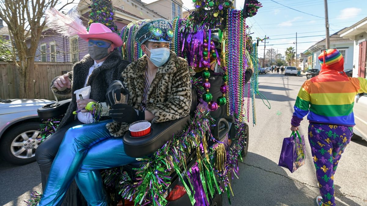 A group of LGBTQ partygoers celebrate Mardi Gras by marching with their homemade float through their neighborhood in New Orleans, Louisiana. Credit: AFP Photo