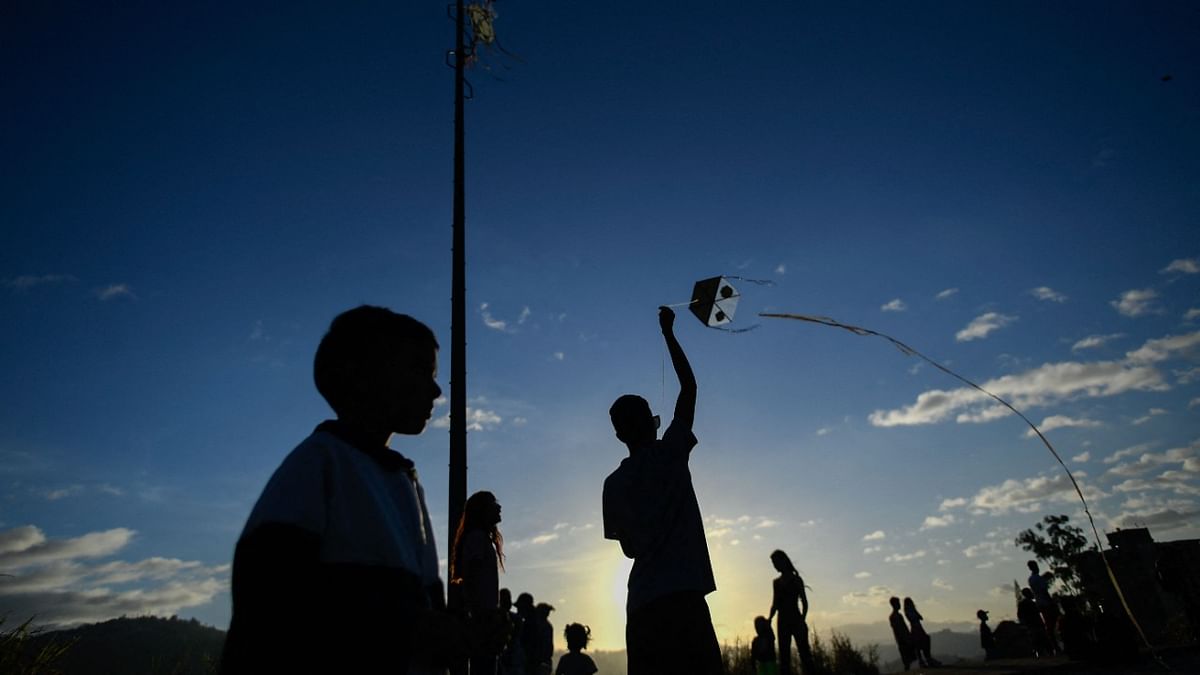 A youngster flies a kite during the commemoration of the 400th anniversary of the Petare neighborhood in Caracas, Venezuela. Credit: AFP Photo