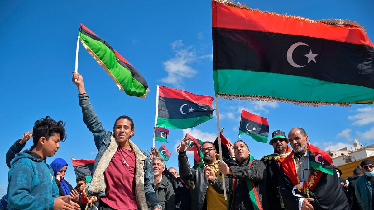 Libyans mark the 10th anniversary of their 2011 uprising that led to the overthrow and killing of longtime ruler Moammar Gadhafi, in Benghazi, Libya. Credit: AP/PTI Photo