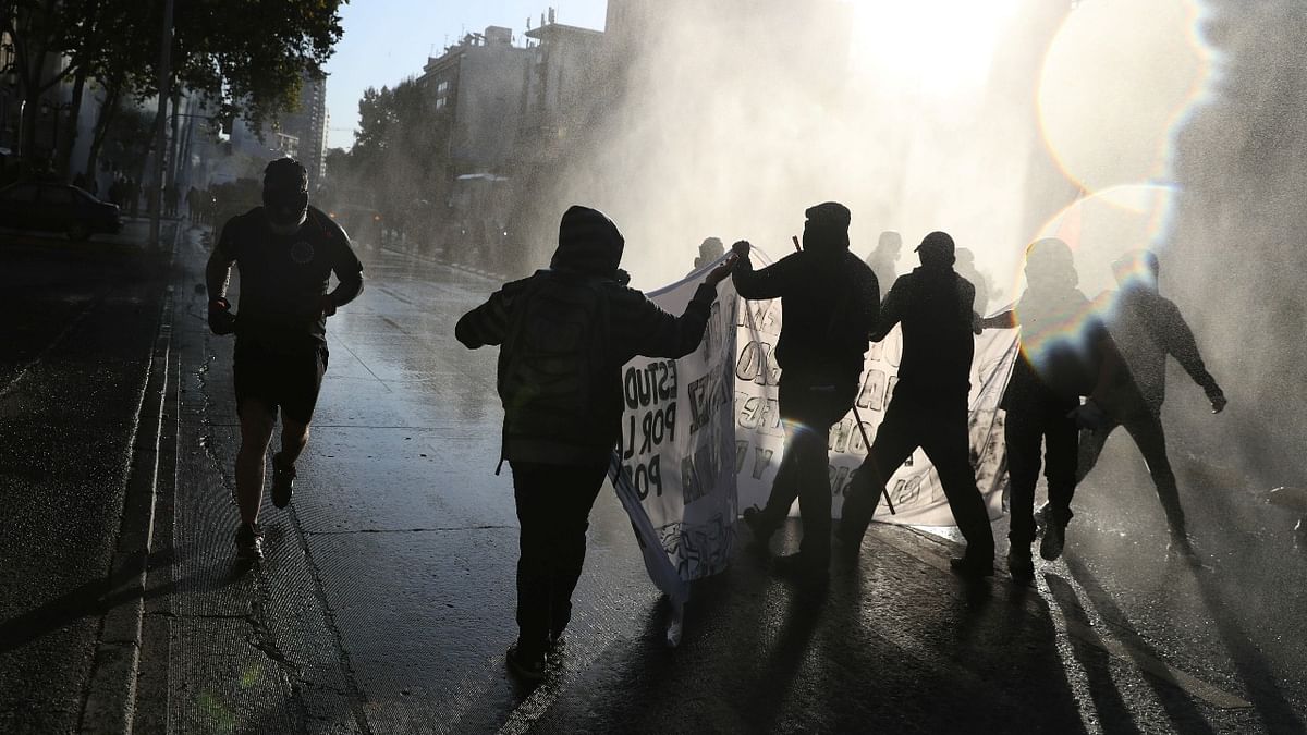 Demonstrators clash with riot police during a protest against Chile's government in Santiago, Chile. Credit: Reuters Photo