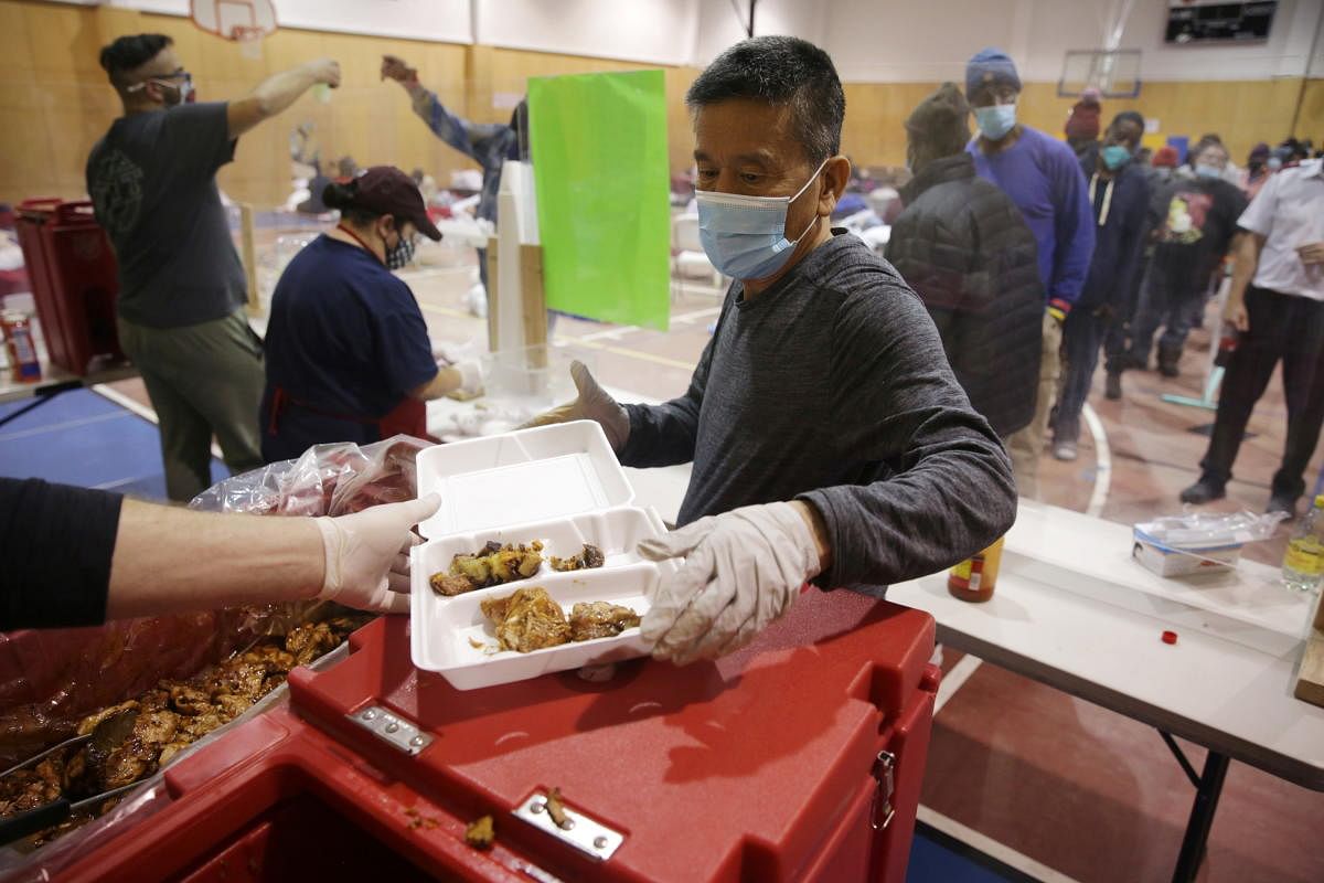 Indy Lee, a volunteer at the Salvation Army, readies a meal to be served as an increased number of people seek refuge after winter weather caused electricity blackouts in Plano, Texas. Credit: Reuters photo.