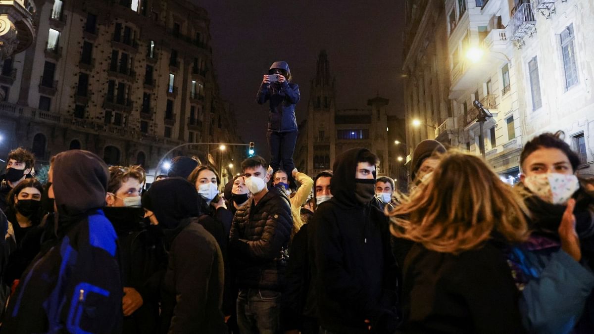 People participate in a protest in support of rap singer Pablo Hasel after he was given a jail sentence on charges of glorifying terrorism and insulting royalty in his songs, in Barcelona, Spain. Credit: Reuters Photo