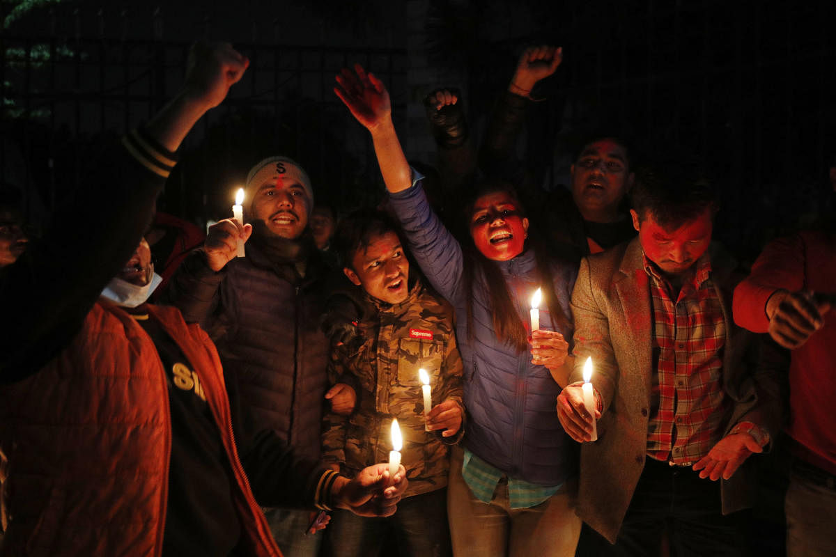 Nepalese supporters of the splinter group in the governing Nepal Communist Party celebrate the Supreme Court order in Kathmandu, Nepal. Credit: AP Photo.