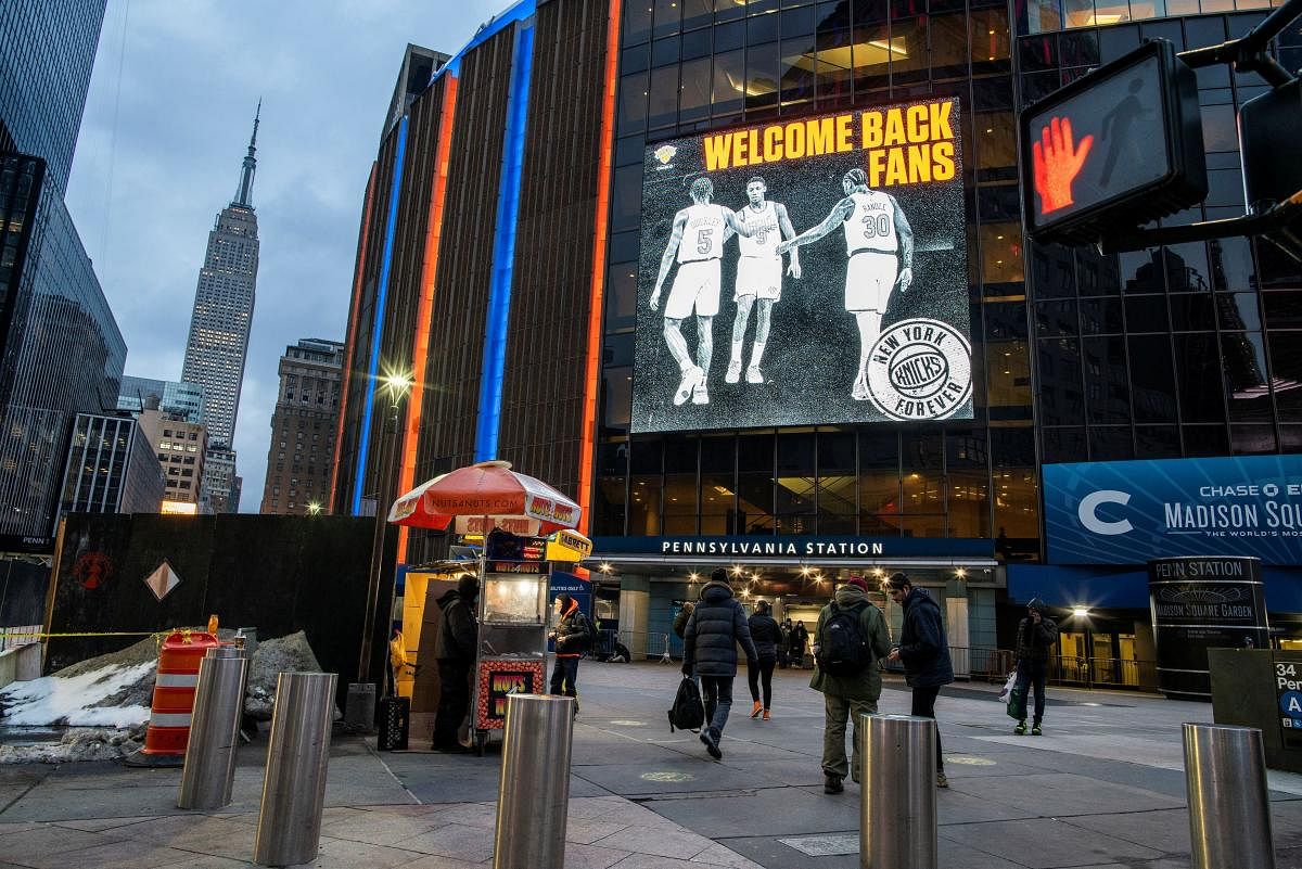 People walk outside Madison Square Garden before a Knicks game amid the coronavirus disease in the Manhattan borough of New York City, New York, US. Credit: Reuters photo.