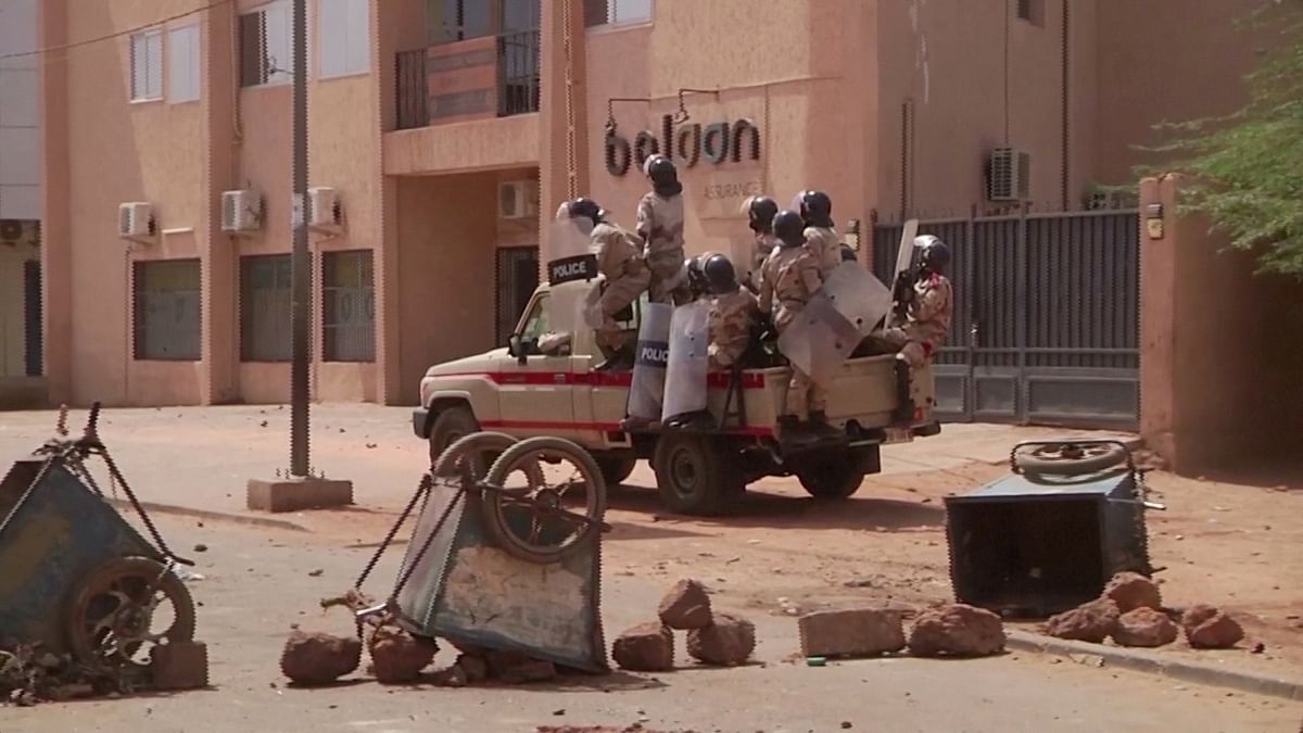 Riot policemen drive towards a group of protesters at a makeshift checkpoint, a day after opposition presidential candidate Mahamane Ousmane rejected election results that gave his opponent Mohamed Bazoum a majority of the votes, in Niamey, Niger, in this still image taken from video. Credit: Reuters/Reuters TV
