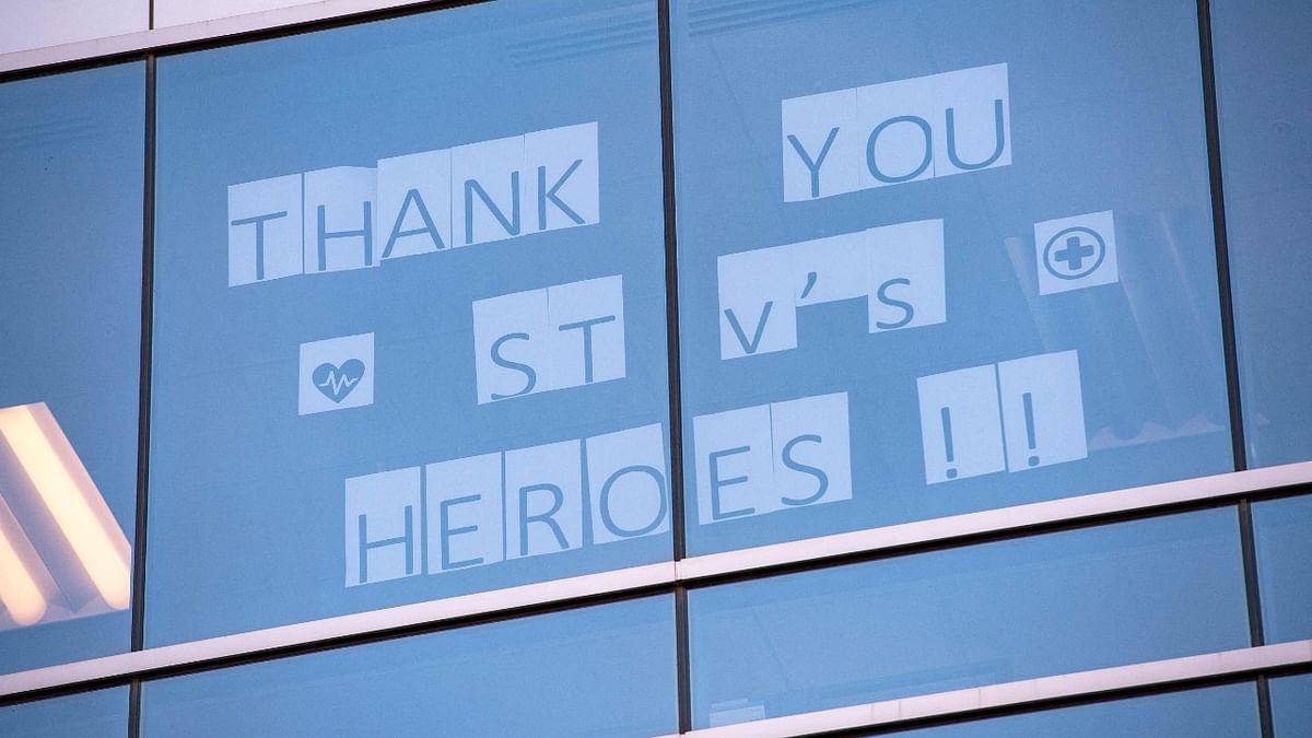 A message displayed on the windows of building facing the St. Vincent Hospital reads