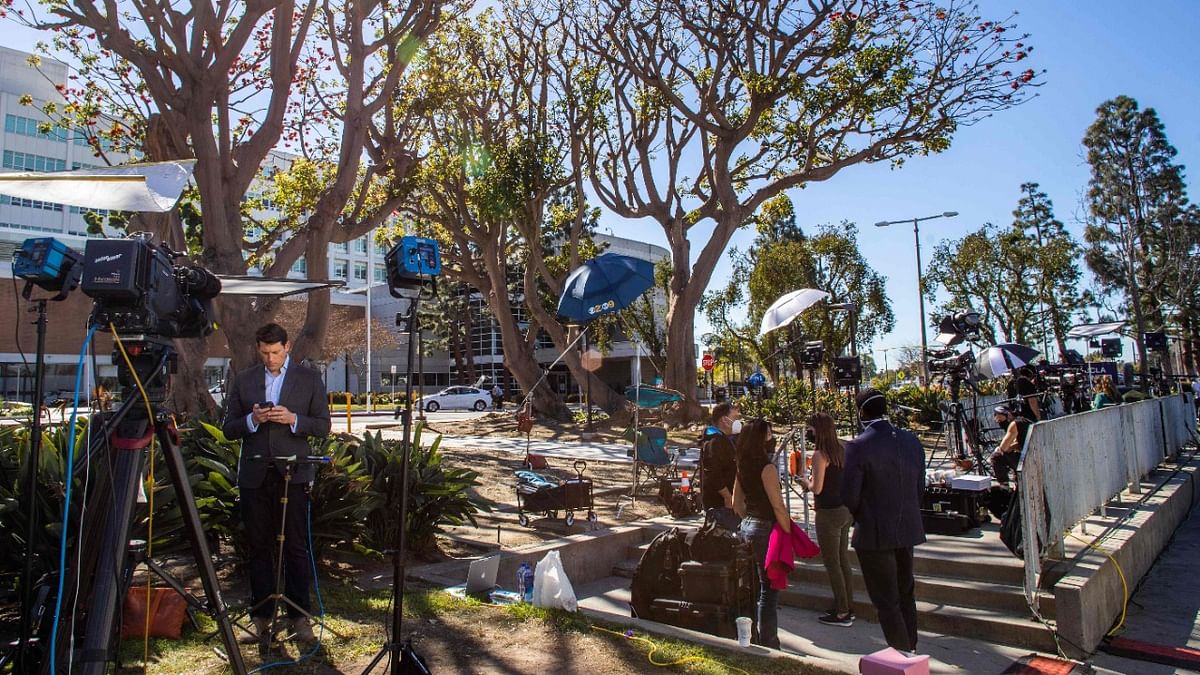 Media reporters gather by the main entrance of the Harbor UCLA Medical Center in Torrance, California on February 24, 2021, where US Golf star Tiger Woods is hospitalised after a roll-over car crash in Palos Verdes, California. Credit: AFP Photo