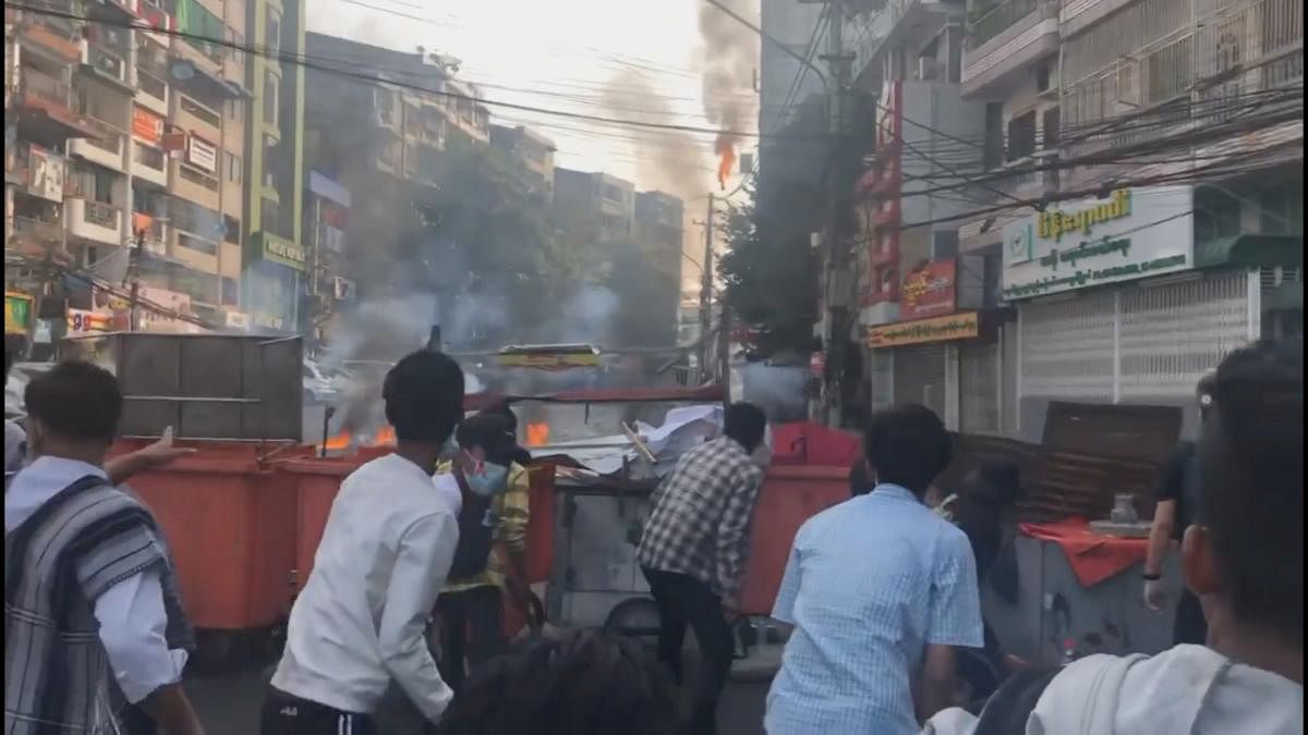 Protesters throw molotov cocktails and objects towards police amid protests against the military coup in Yangon, Myanmar February 28, 2021 in this screen grab from a social media video. Credit: Reuters