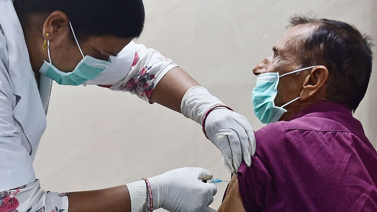 A medical worker prepares to inoculate a man with a Covid-19 vaccine at Moti Lal Nehru Medical College in Allahabad as India has opened up the jabs to all over-60s and any over-45s with serious illnesses. Credit: AFP Photo