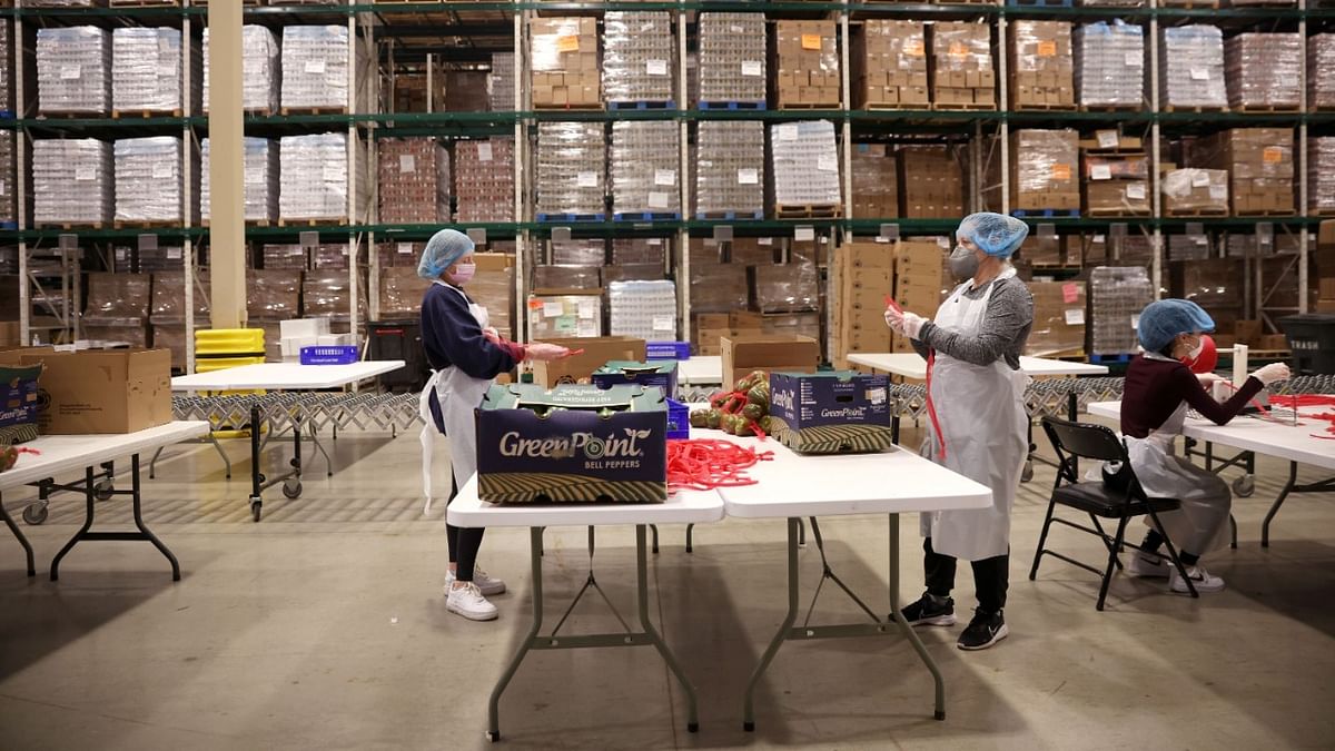 Volunteers pack bell peppers for distribution through food pantries to people in need at the Greater Chicago Food Depository in Chicago, Illinois. Credit: AFP Photo