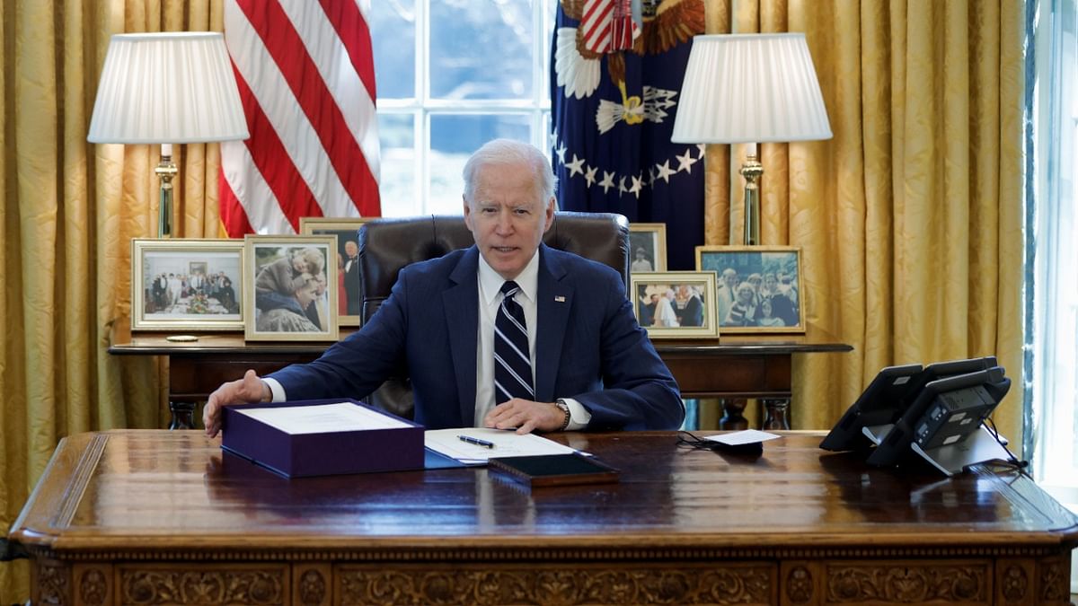 US President Joe Biden looks on after signing the American Rescue Plan, a package of economic relief measures to respond to the impact of the Covid-19 pandemic, inside the Oval Office at the White House in Washington, US. Credit: Reuters Photo