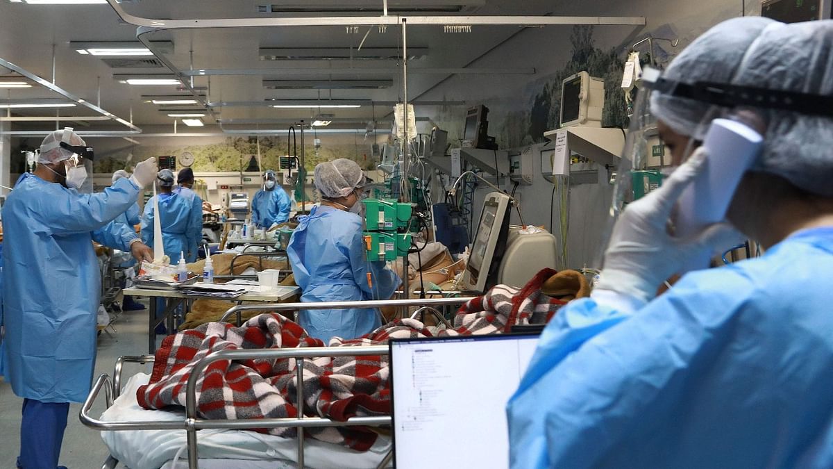 Health workers care for patients infected with Covid-19 at the full emergency room of the Nossa Senhora da Conceiao hospital in Porto Alegre, Rio Grande do Sul State, in southern Brazil. Credit: AFP Photo