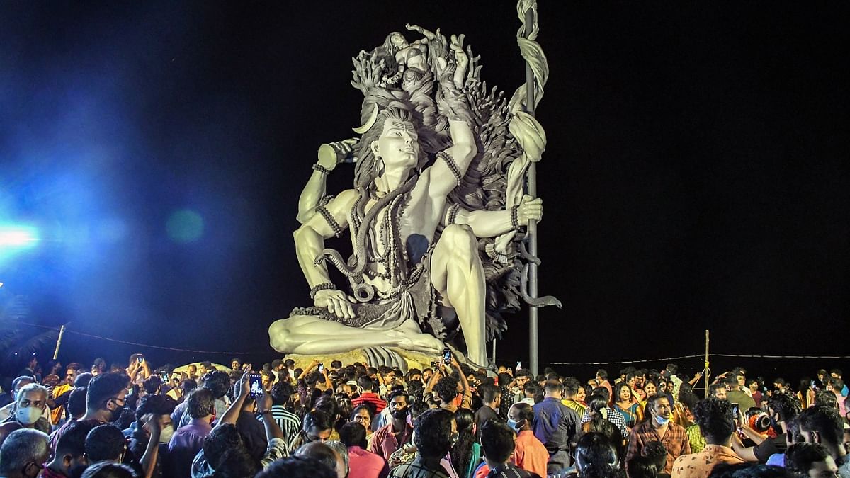 Devotees offer prayers near the giant sculpture of Lord Shiva Gangadhareshwara at Azhimala Shiva temple on the occasion of Mahashivarathri festival, in Thiruvananthapuram. Credit: PTI Photo