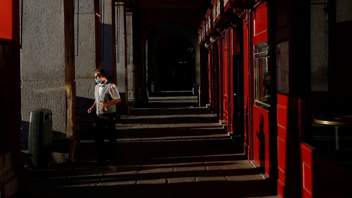 A waiter works at the terrace of a bar, amid the Covid-19 pandemic, in Madrid, Spain. Credit: Reuters Photo