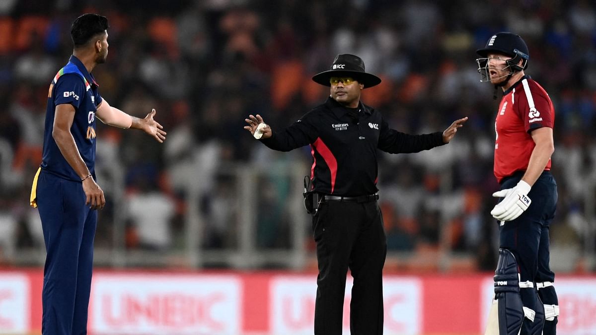 England's Jonny Bairstow (R) speaks with India's Washington Sundar (L) as umpire gestures during the first Twenty20 international cricket match between India and England at the Narendra Modi Stadium in Motera. Credit: AFP Photo