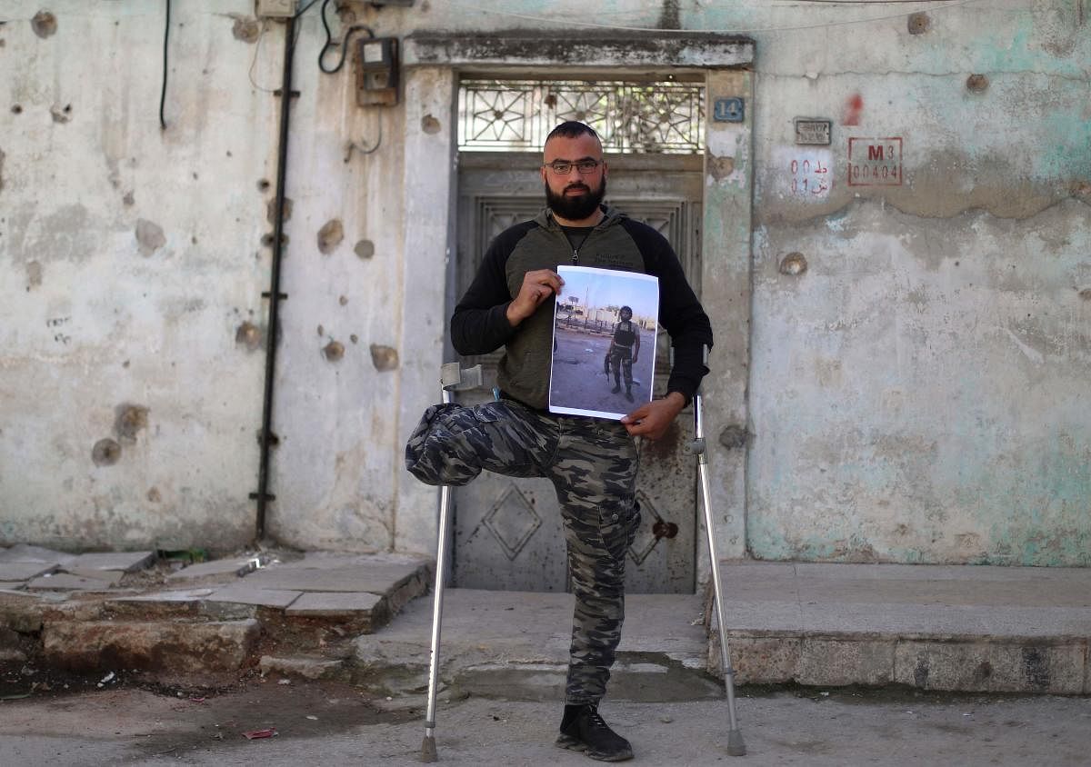 In Idlib city, former rebel fighter 28-year-old Mohammed al-Hamid leans on crutches, holding a large picture showing him before the war in a military uniform and holding a weapon.  He says he was wounded in a 2016 battle against government forces in Latakia, where his brother also died in his arms.  That same year, he learnt that three other siblings had died in prison.  In 2017, warplanes bombarded his home in Idlib, killing his daughter.