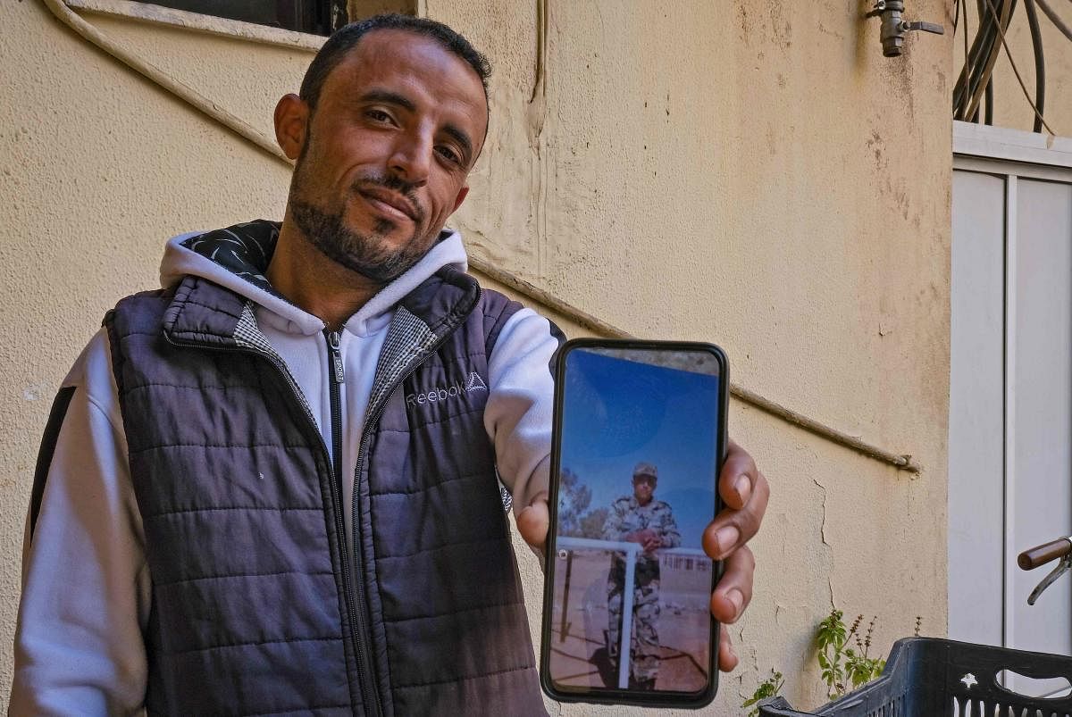 Fahad al-Routayban, 30, works as a building concierge in the northern Lebanese city of Tripoli.  On his smartphone, he pulled up an image showing him in uniform during his military service in 2010.