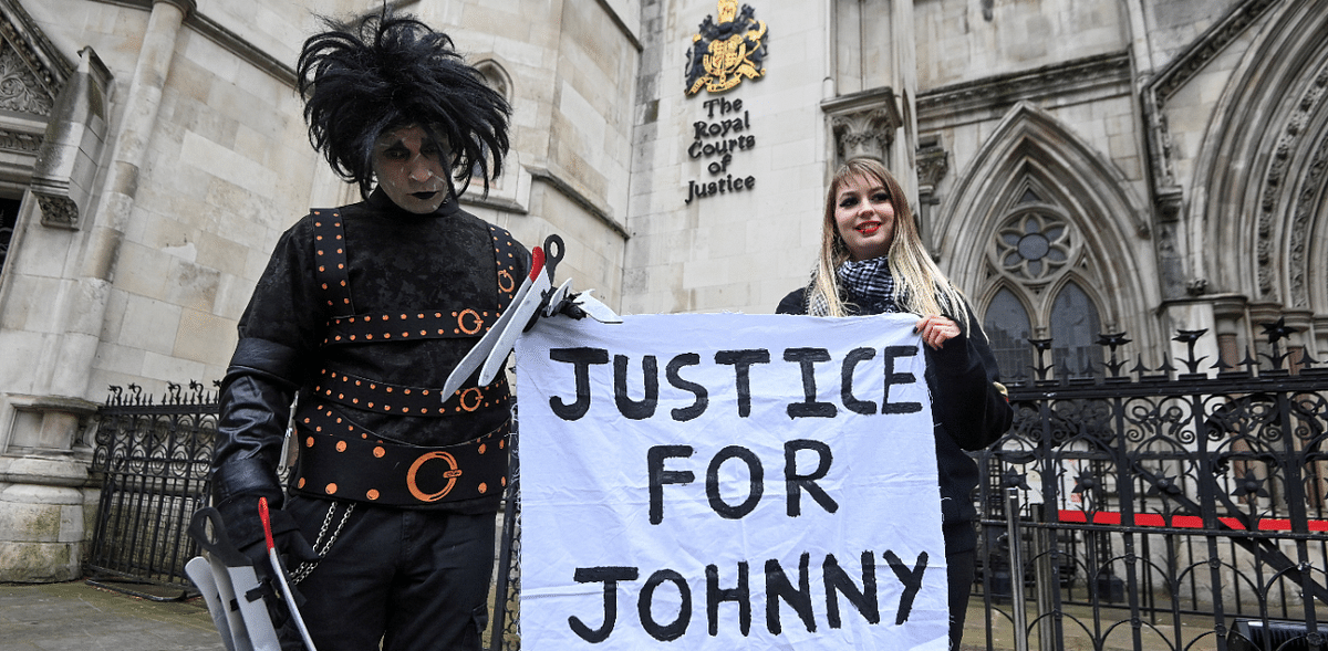 Supporters of actor Johnny Depp pose outside the High Court in London. Credit: Reuters Photo