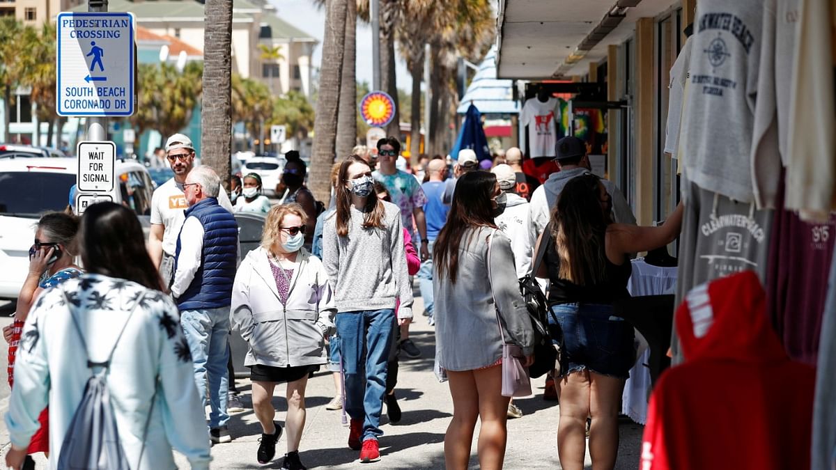 Beachgoers wear masks while vacationing on Clearwater Beach during Spring Break, as the coronavirus disease (Covid-19) pandemic continues, in Clearwater, Florida, US. Credit: Reuters Photo