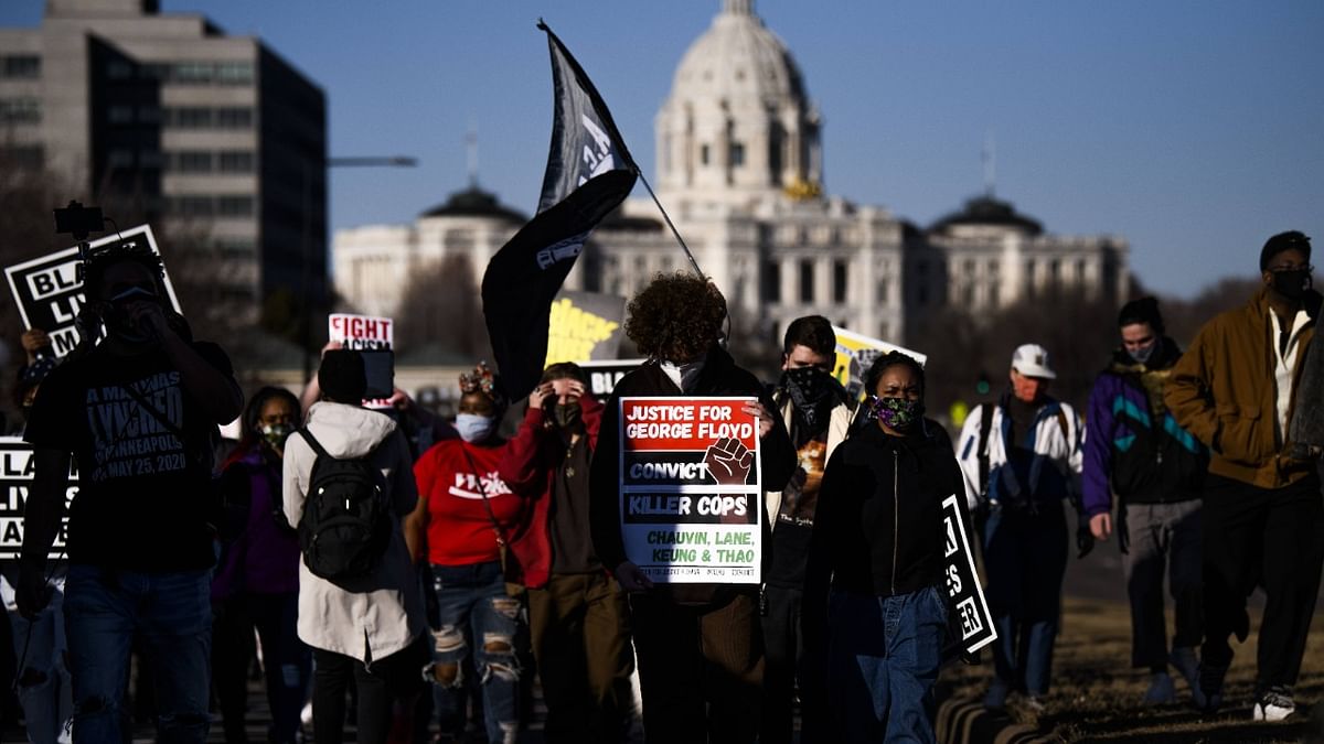 People march near the Minnesota State Capitol to honor George Floyd in Minnesota. This morning Judge Peter Cahill rejected motions for change of venue and continuance by the defense of former Minneapolis Police officer Derek Chauvin, who is accused of killing George Floyd last May. Credit: AFP Photo