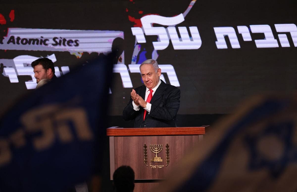 Israeli Prime Minister Benjamin Netanyahu, leader of the Likud party, prepares to address supporters at the party campaign headquarters in Jerusalem early on March 24, 2021, after the end of voting in the fourth national election in two years. Credit: AFP Photo