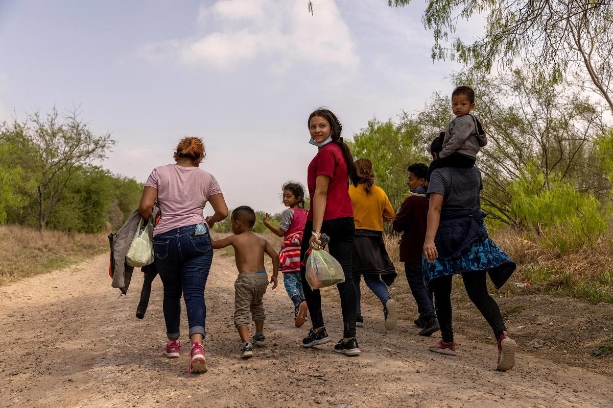 Asylum seekers from Honduras walk towards a U.S. Border Patrol checkpoint after crossing the Rio Grande from Mexico. Credit: AFP Photo