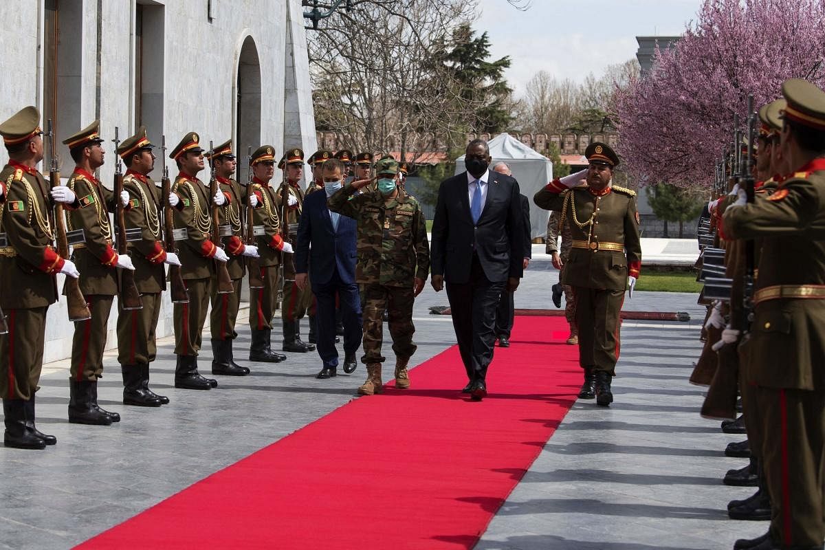 US Secretary of Defense Lloyd J. Austin III(L) as he is welcomed with an honor cordon as he arrives at the presidential palace for a meeting with with Afghan President Ashraf Ghani, in Kabul, Afghanistan. Credit: AFP Photo