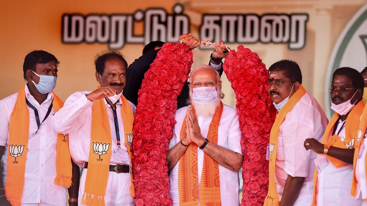 Prime Minister Narendra Modi being garlanded by party leaders during a public meeting ahead of the UT assembly elections, in Puducherry, Thursday, February 25, 2021.  Credit: PTI File Photo