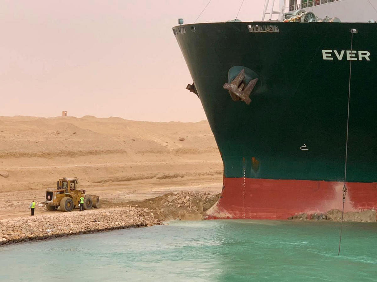 So far, dredgers have tried to clear silt around the massive ship. Tug boats nudged the vessel alongside it, trying to gain momentum. From the shore, at least one backhoe dug into the canal's sandy banks, suggesting the bow of the ship had plowed into it.  Credit: AFP Photo