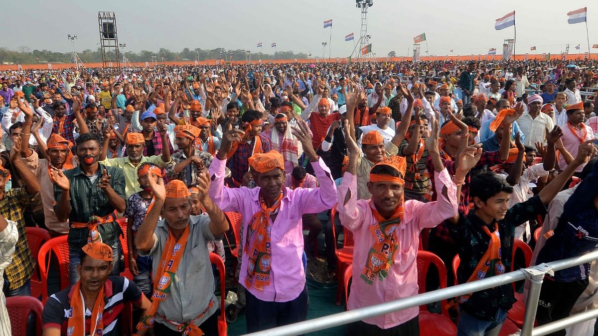 Supporters of Bharatiya Janata Party (BJP) cheer during a public meeting ahead of Assam Assembly elections in Sipajhar on the outskirts of Guwahati on March 24, 2021. Credit: PTI File Photo