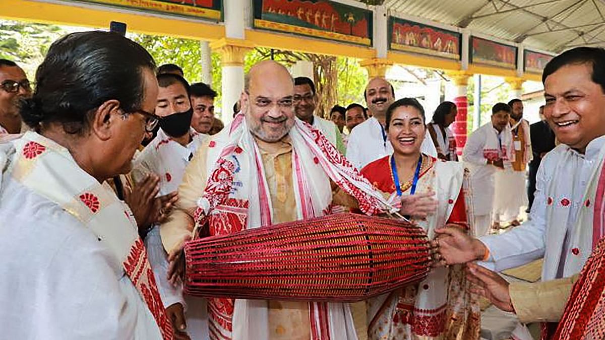 Union Home Minister Amit Shah plays an instrument inside Batadrava Than, the birthplace of Srimanta Sankardev, in Nagaon District of Assam. Credit: PTI File Photo