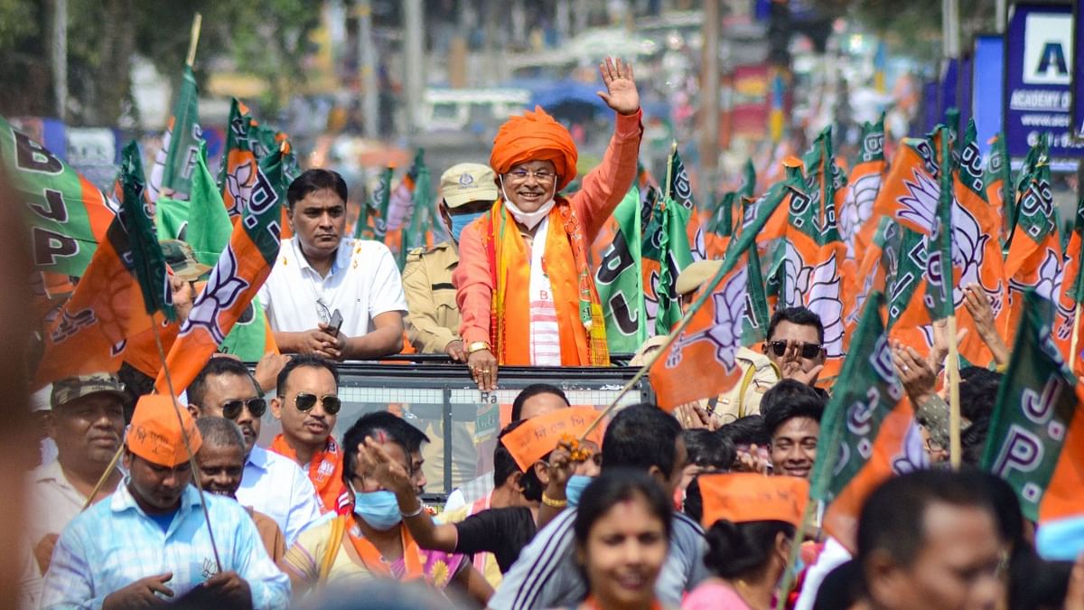 BJP candidate Prasanta Phukan waves at his party worker during a rally towards Deputy Commissioners' Office to file his nomination ahead of the elections, in Dibrugarh, Monday, March 8, 2021. Credit: PTI File Photo
