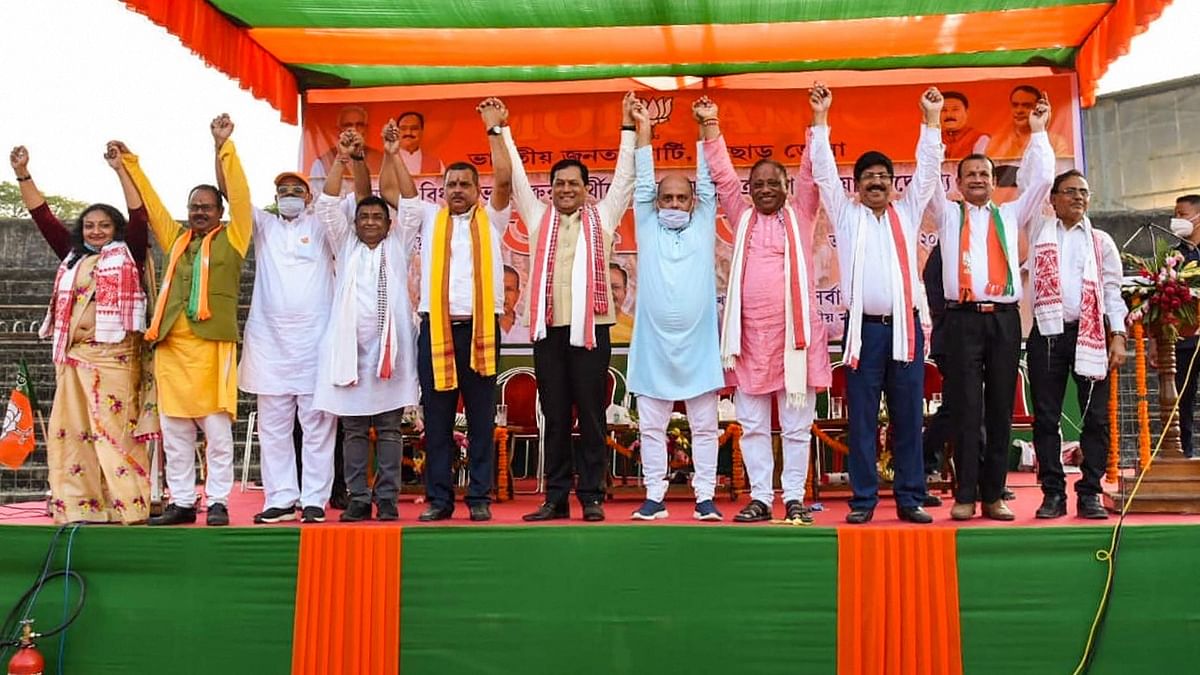 Assam Chief Minister Sarbananda Sonowal (C) along with State Fishery Minister Parimal Suklabaidya (4R) and others during a public meeting in support of the party candidate, ahead of state assembly polls, at Silchar in Cachar district, Thursday, March 11, 2021. Credit: PTI File Photo