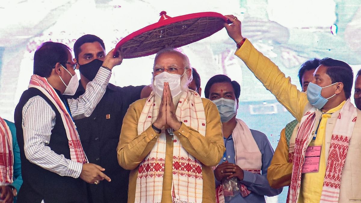 Prime Minister Narendra Modi being felicitated with an 'Assamese Japi' during an election campaign rally ahead of the Assam Assembly polls , at Sipajhar in Darrang district, Wednesday, March 24, 2021. Credit: PTI Photo