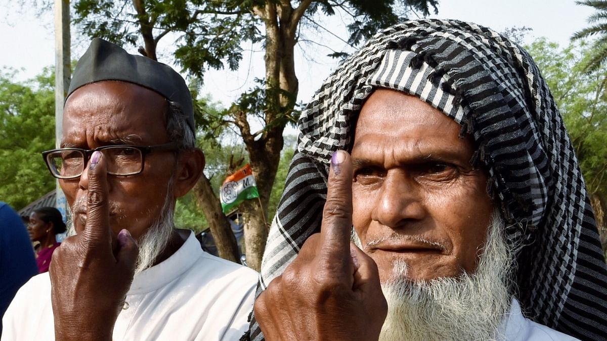 Elderly voters show their marked fingers after casting votes during the first phase of West Bengal Assembly elections, at Betkunduri in Jhargram. Credit: PTI Photo