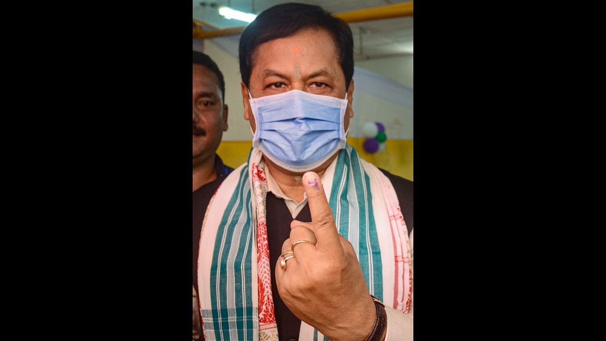 Assam CM Sarbananda Sonowal shows his finger marked with indelible ink after casting vote at a polling station, during the first phase of Assam Assembly elections, in Dibrugarh district. Credit: PTI Photo