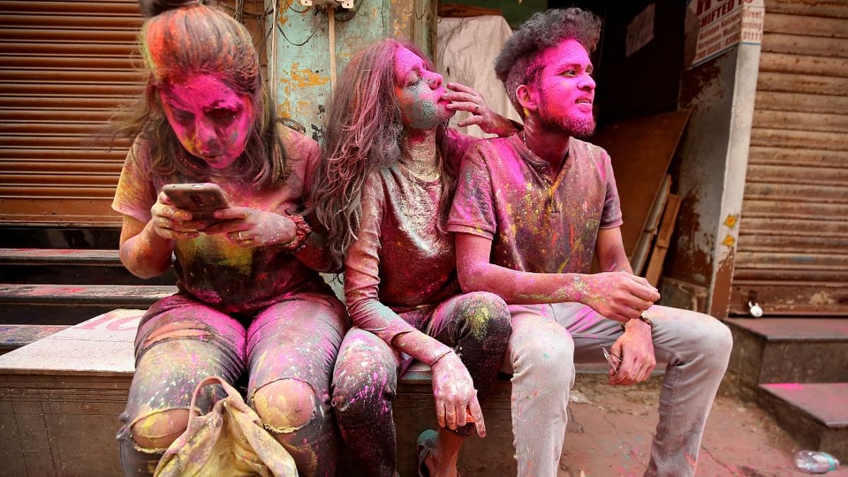 Chennai: People are seen taking a break during Holi celebrations. Credit: Reuters Photo
