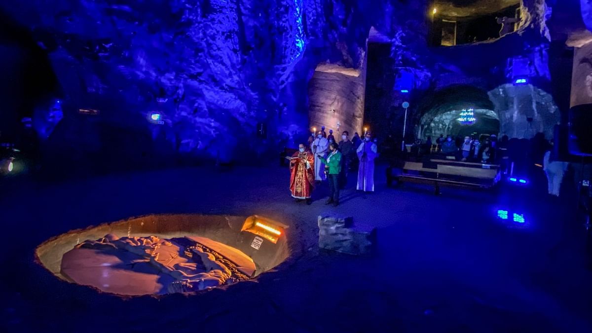 A Catholic priest conducts the traditional Palm Sunday mass, which marks the beginning of Holy Week celebrations, in the Salt Cathedral of Zipaquira, an underground church built into a salt mine, in Zipaquira, 45 km north of Bogota, on March 28, 2021. Credit: AFP Photo