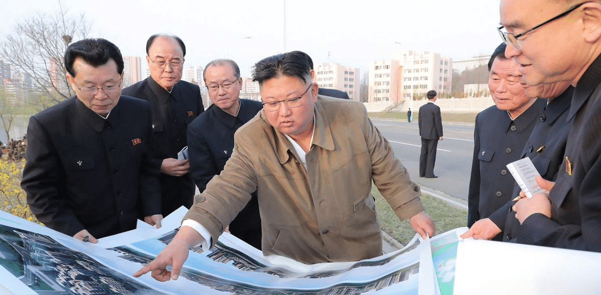 This undated picture released from North Korea's official Korean Central News Agency (KCNA) on April 1, 2021 shows North Korean leader Kim Jong Un (C) inspecting the construction site of the residential district of terraced apartment buildings on the bank of the River Pothong in Pyongyang. Credit: AFP photo.