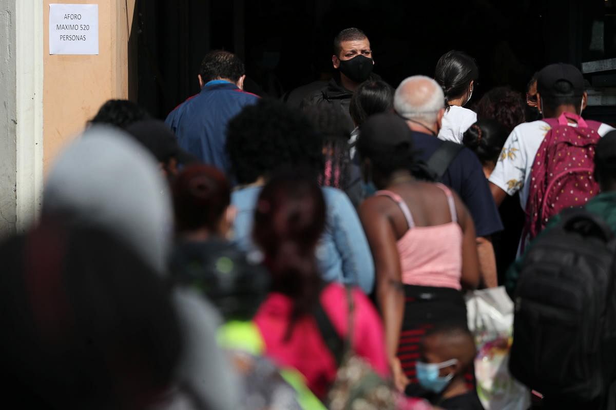 A security worker supervises the entry to a market, as the coronavirus disease cases exceed one million in Santiago, Chile. Credit: Reuters photo.