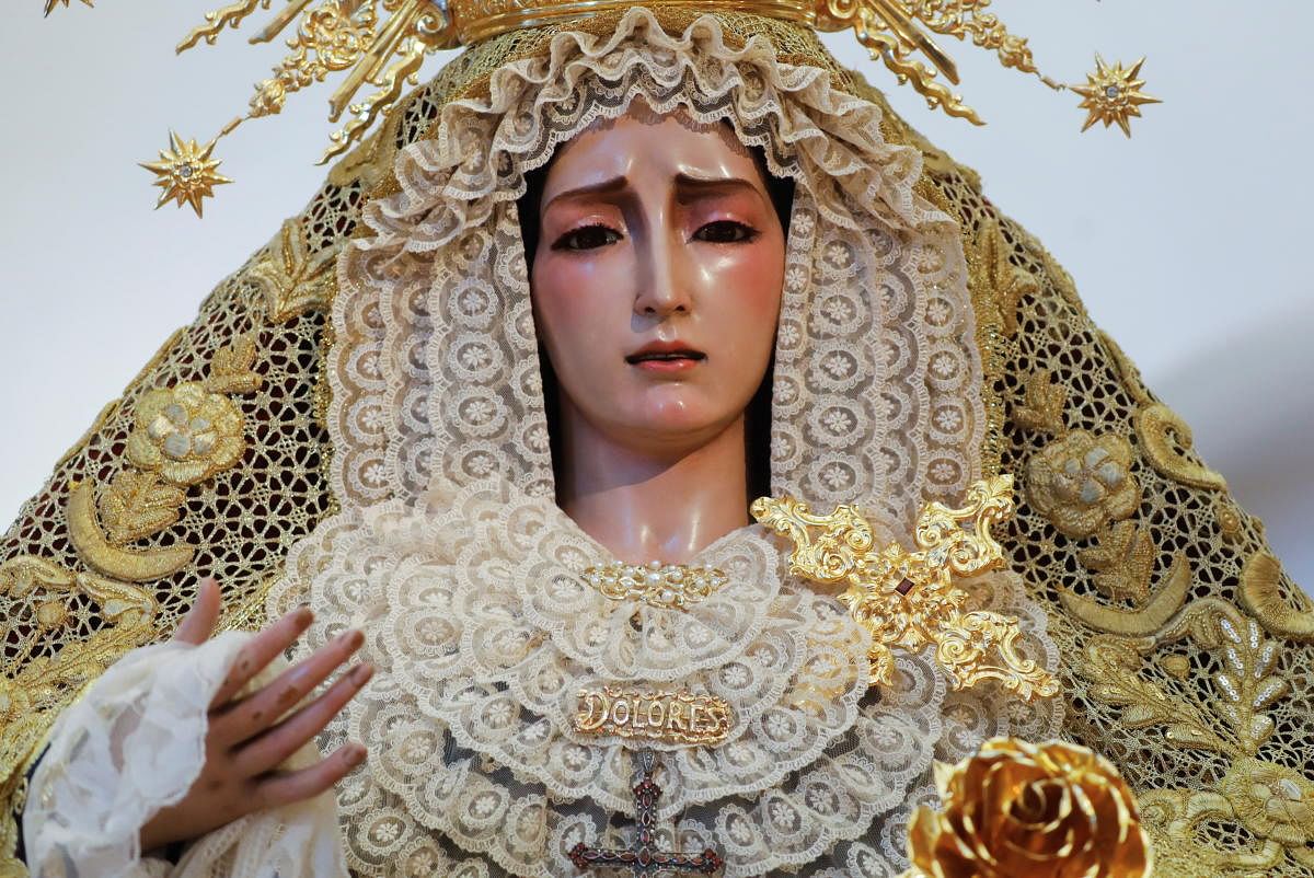 The statue of Virgin of the Dolores, prepared to be venerated by the faithful, is seen inside a church during the Holy Week, after the annual processions were cancelled due to the coronavirus disease in Ronda, Spain. Credit: Reuters photo.