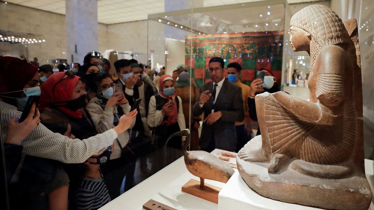 Visitors look at displayed exhibits as they visit the National Museum of Egyptian Civilization after its reopening in Cairo, Egypt. Credit: Reuters Photo