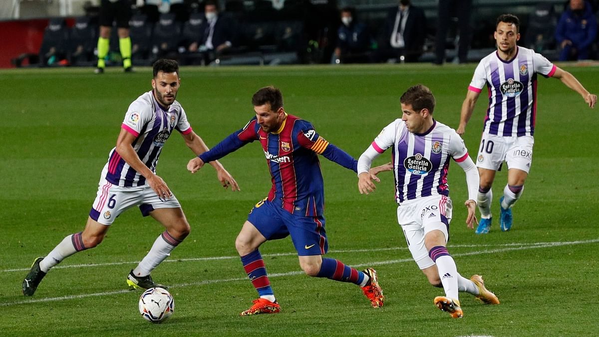 FC Barcelona's Lionel Messi weaves through Real Valladolid's defence during a La Liga match. Credit: Reuters Photo