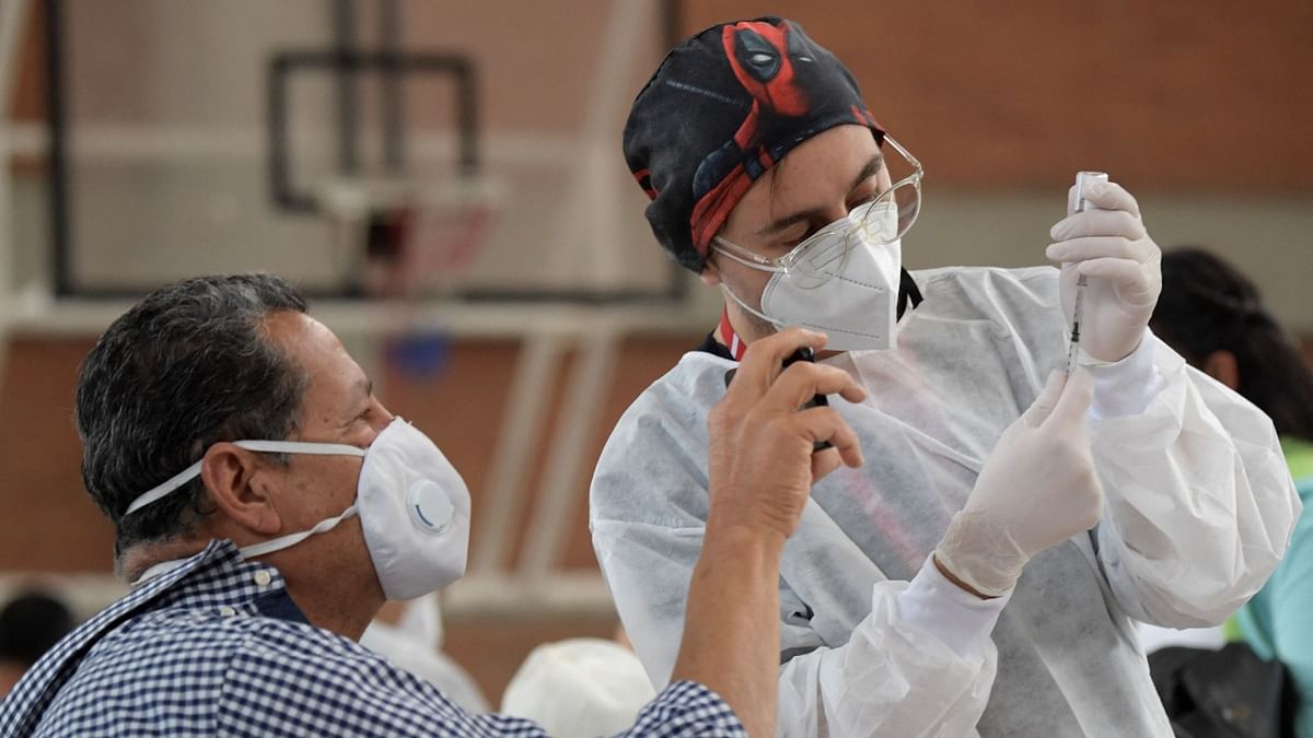 A man record with his cellphone before being inoculated with the Oxford/AstraZeneca vaccine against Covid-19 amid the coronavirus pandemic, in Bogota. Credit: AFP Photo
