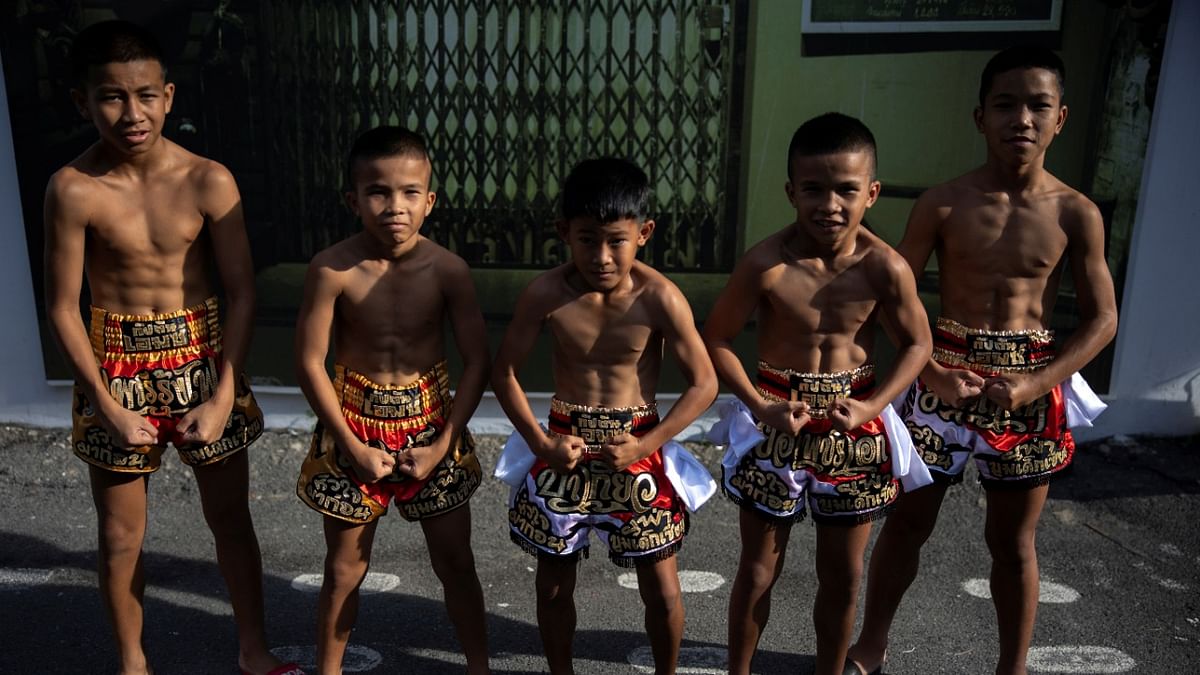 Muay Thai boxers pose for a photograph at the Rangsit Boxing stadium in Pathum Thani province, Thailand. Credit: Reuters Photo