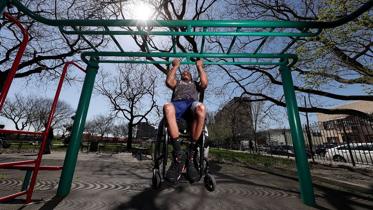 Team USA Para Powerlifter Garrison Redd trains in his wheelchair doing chin-ups in Robert E. Venable Park in Brooklyn, New York. Credit: AFP Photo