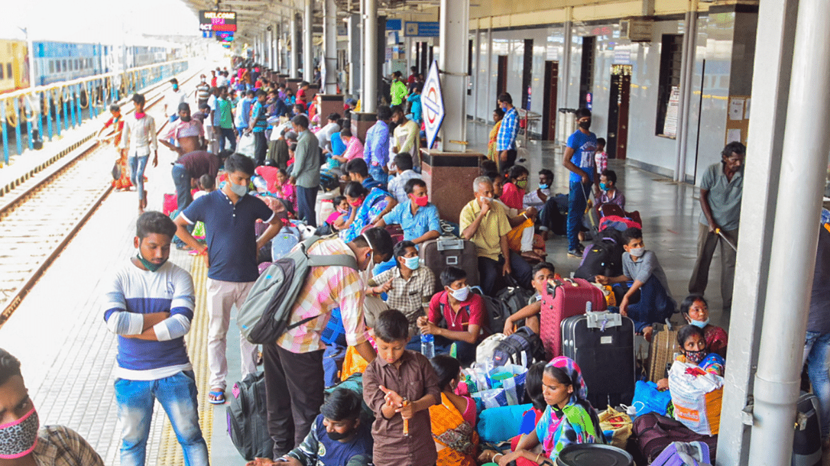 Migrant workers from Kolkata, in large numbers, wait to board a train amid rise in COVID-19 cases across the country, at Trichy railway junction. Credit: PTI Photo