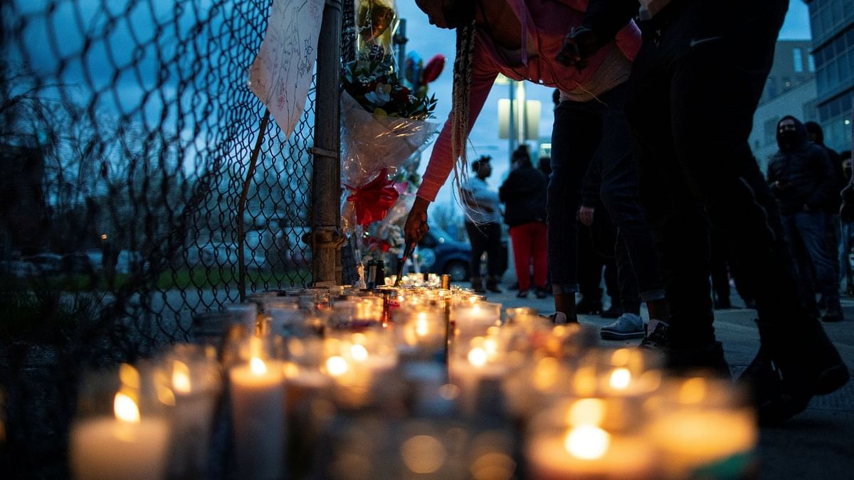 A fan lights candles at a makeshift memorial for musician and actor DMX outside White Plains Hospital, after he died at the age of 50 in White Plains, New York. Credit: Reuters.